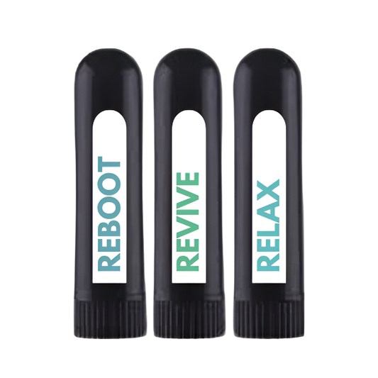 Three black nasal inhalers with different words printed on them. The first one says 'REBOOT', the second one says 'RELAX', and the third one says 'RX'.