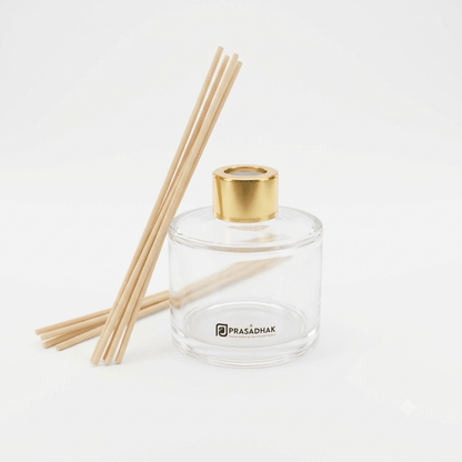 Prasadhak 120ml clear glass reed diffuser bottle with gold-tone cap and reed sticks