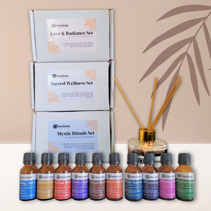 Prasadhak Love & Radiance Set flat-lay with essential oil bottles, sage smudge stick and affirmation cards