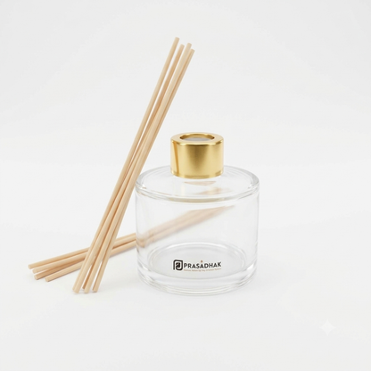 Prasadhak 120ml clear glass reed diffuser bottle with gold-tone cap and reed sticks