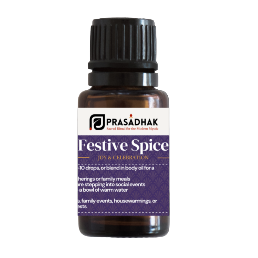 Bottle of Prasadhak Festive Spice essential oil on a white background