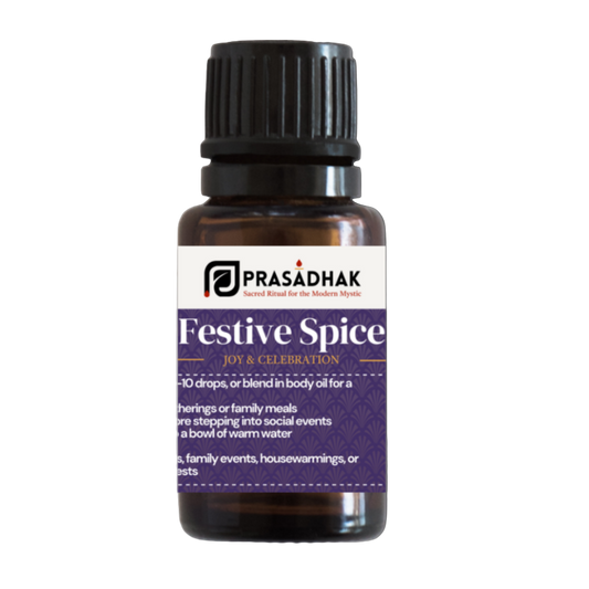 Bottle of Prasadhak Festive Spice essential oil on a white background