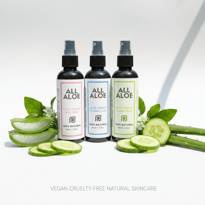 Three bottles of prasadhak ALL ALOE Face Toner in different flavors (Alcohol Free, Lemon Lime, and Mint) arranged on a white background with fresh aloe vera slices, cucumber slices, and green leaves. The text 'VEGAN CRUELTY-FREE NATURAL SKINCARE' is written at the bottom.