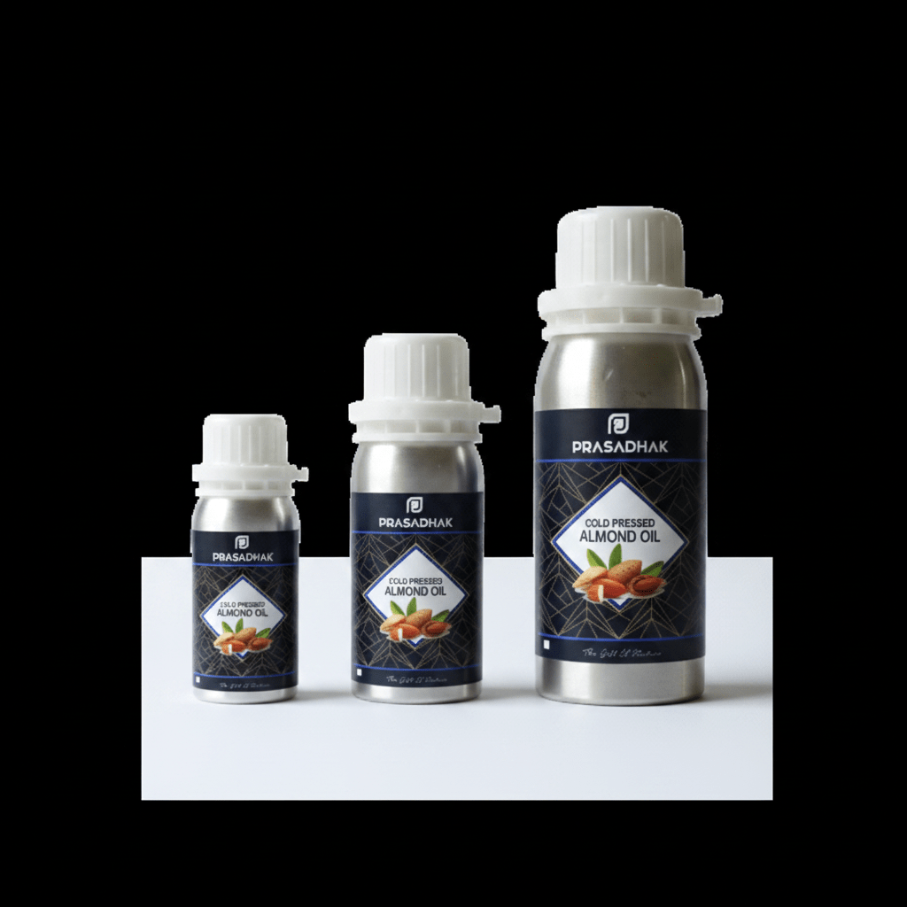Three bottles of Prasadhak Gold-Premium Almond Oil in silver aluminum packaging with white caps, arranged by size on a white platform against a solid black background.