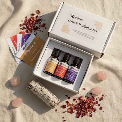 An open white gift box labeled 'Love & Radiance Set' containing three small essential oil bottles