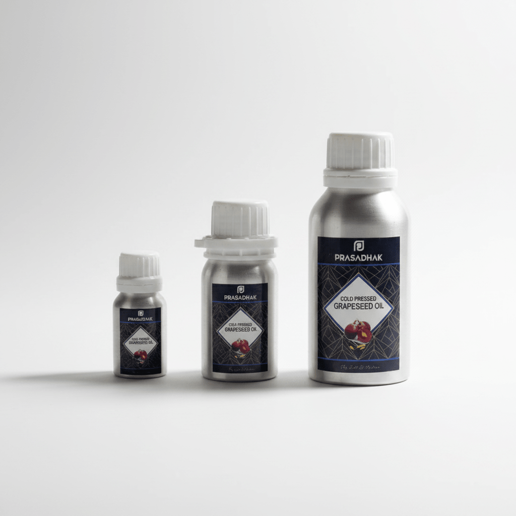 Three silver metal bottles of Prasadhak cold-pressed grapeseed oil in different sizes, arranged by height on a light gray background.