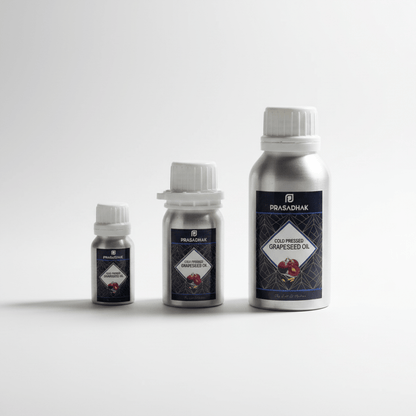 Three silver metal bottles of Prasadhak cold-pressed grapeseed oil in different sizes, arranged by height on a light gray background.