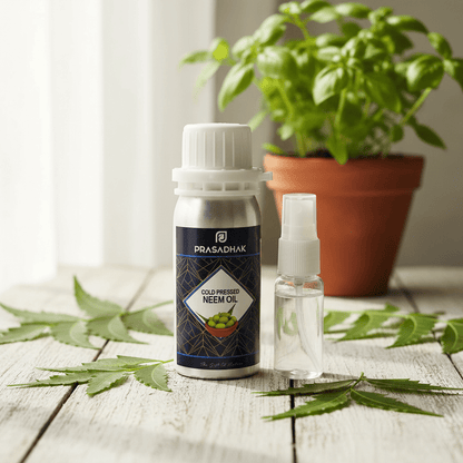 A bottle of Prasadhak Cold pressed Neem Oil and a small spray bottle displayed on a rustic wooden table with green neem leaves and a potted basil plant in the background.